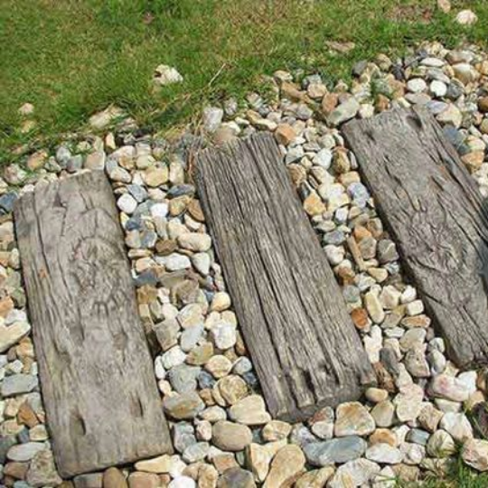 Stepping stone path with reused old pieces of wood as steps